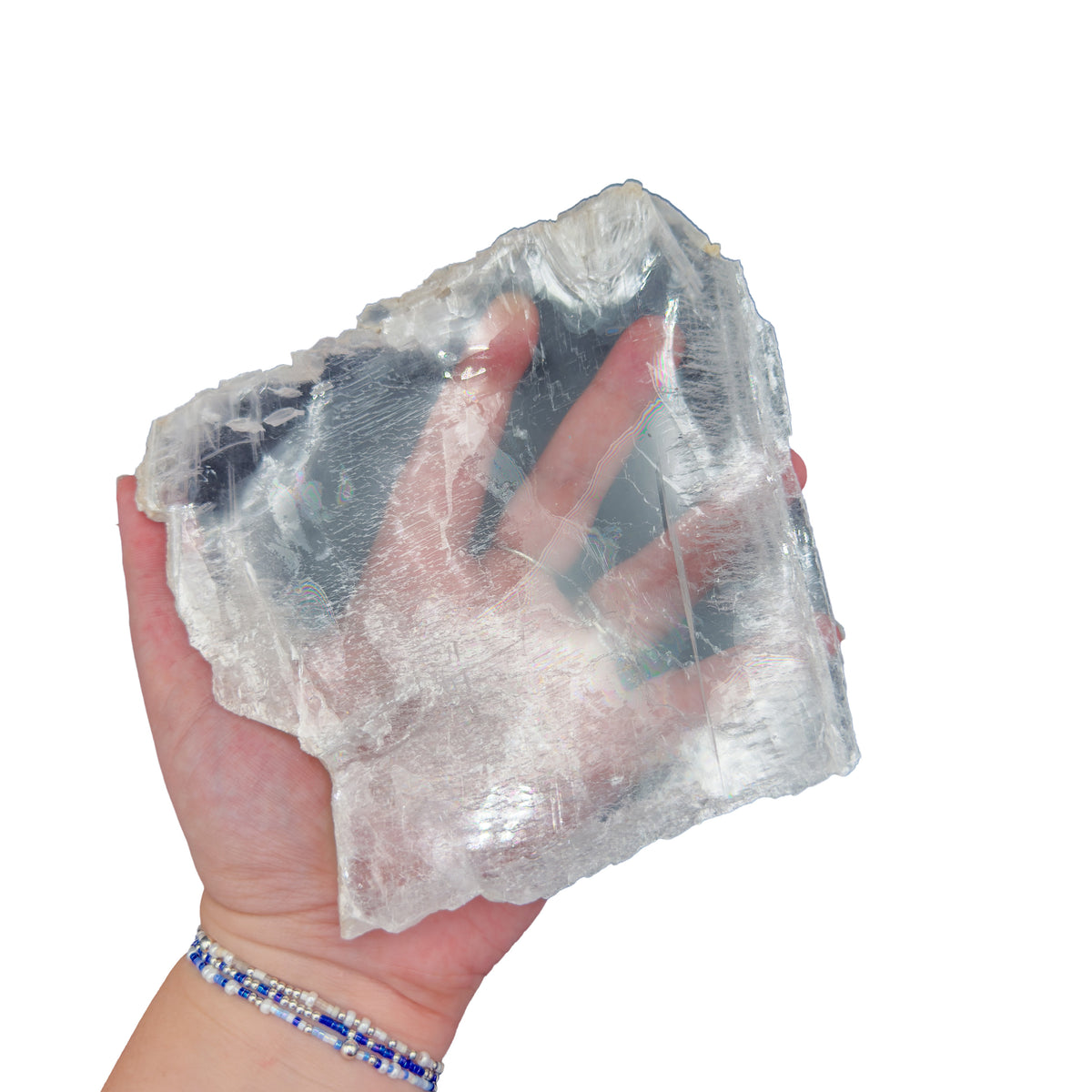 Selenite clearing slab from New Mexico held in an open hand, backlit to show translucency, 0.70 pound piece, specimen 59.