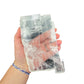 Selenite clearing slab from New Mexico held in an open hand, backlit to show translucency, 0.66 pound piece, specimen 60.