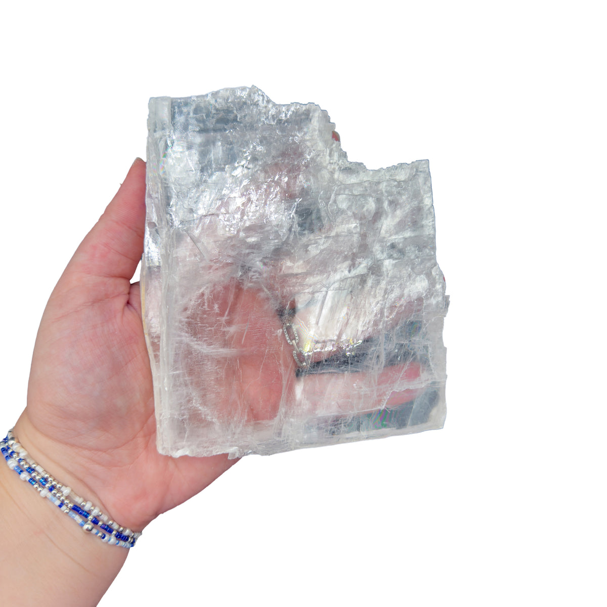 Selenite clearing slab from New Mexico held in an open hand, backlit to show translucency, 0.74 pound piece, specimen 61.