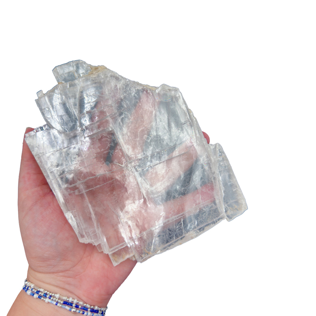 Selenite clearing slab from New Mexico held in an open hand, backlit to show translucency, 0.97 pound piece, specimen 63.