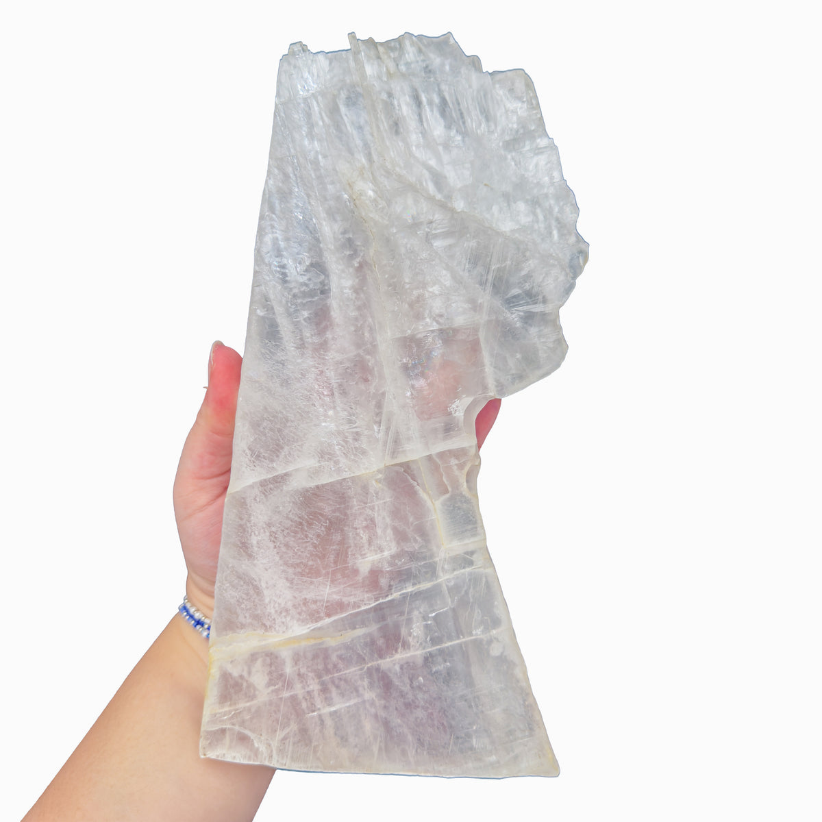 Selenite standing slab from New Mexico held in an open hand, backlit to show translucency, 3.39 pound piece, specimen 52.