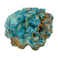 Single raw Chrysocolla and Shattuckite stone in bright turquoise, with rust-colored iron staining running through the host rock at its base.