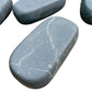 Reverse angle of black Shungite palm stone, showing earthy tone, worked with for Protection.