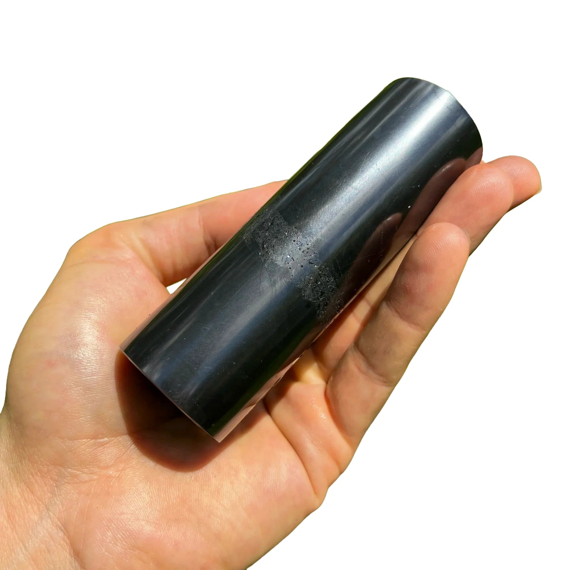 Holding a Shungite stone, from Republic of Karélia, Russia, with surface texture in view.