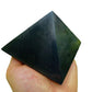 Daylight view of a Shungite polished pyramid associated with Protection and Cleansing.