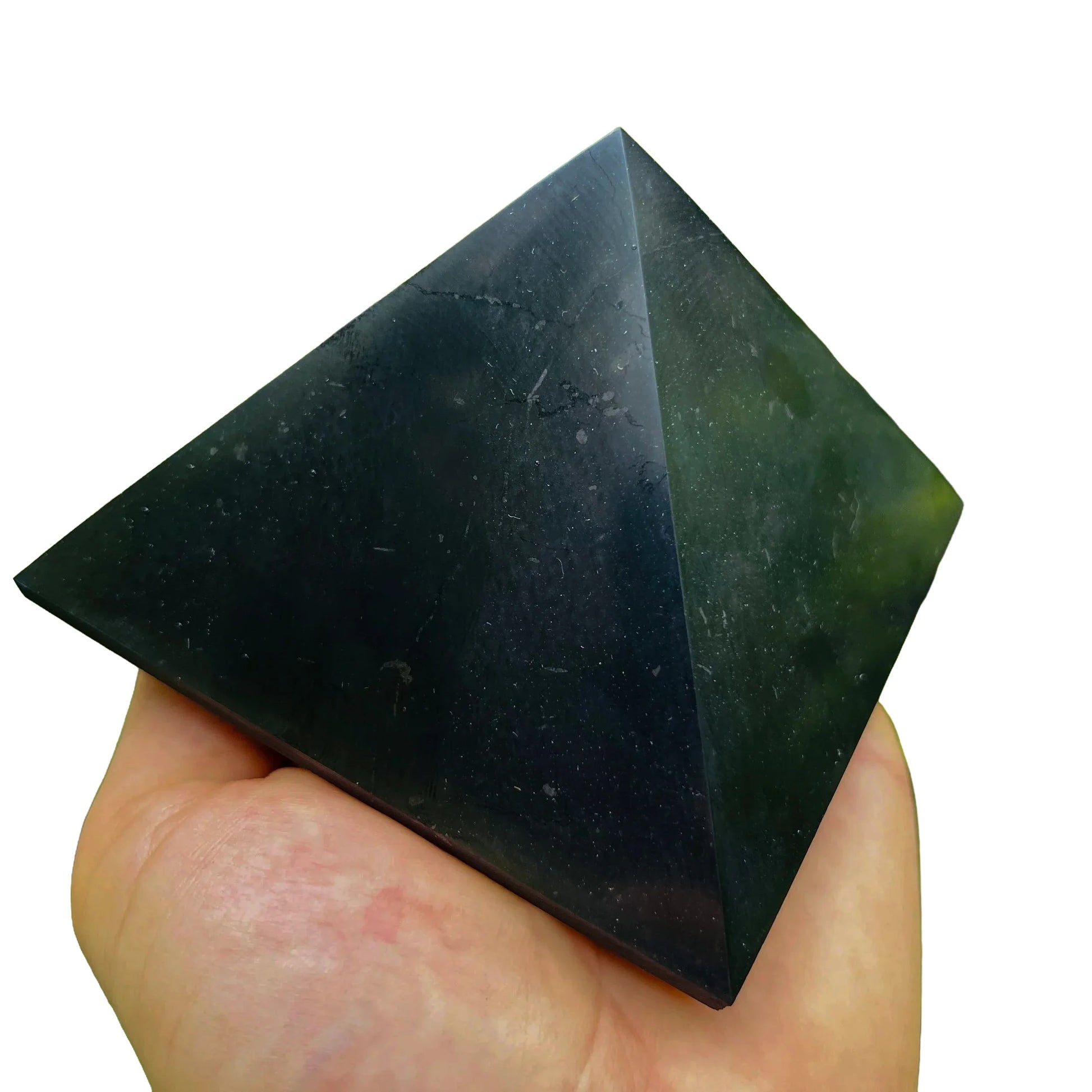 Daylight view of a Shungite polished pyramid associated with Protection and Cleansing.