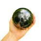 Whole-piece view of Shungite stone, associated with Grounding, in the warmth of daylight.