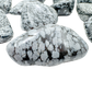Close view of Snowflake Obsidian tumbled stone showing grey cristobalite snowflakes on black volcanic glass
