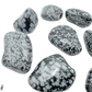 Snowflake Obsidian tumbled stones angled to show satin polish and pattern contrast