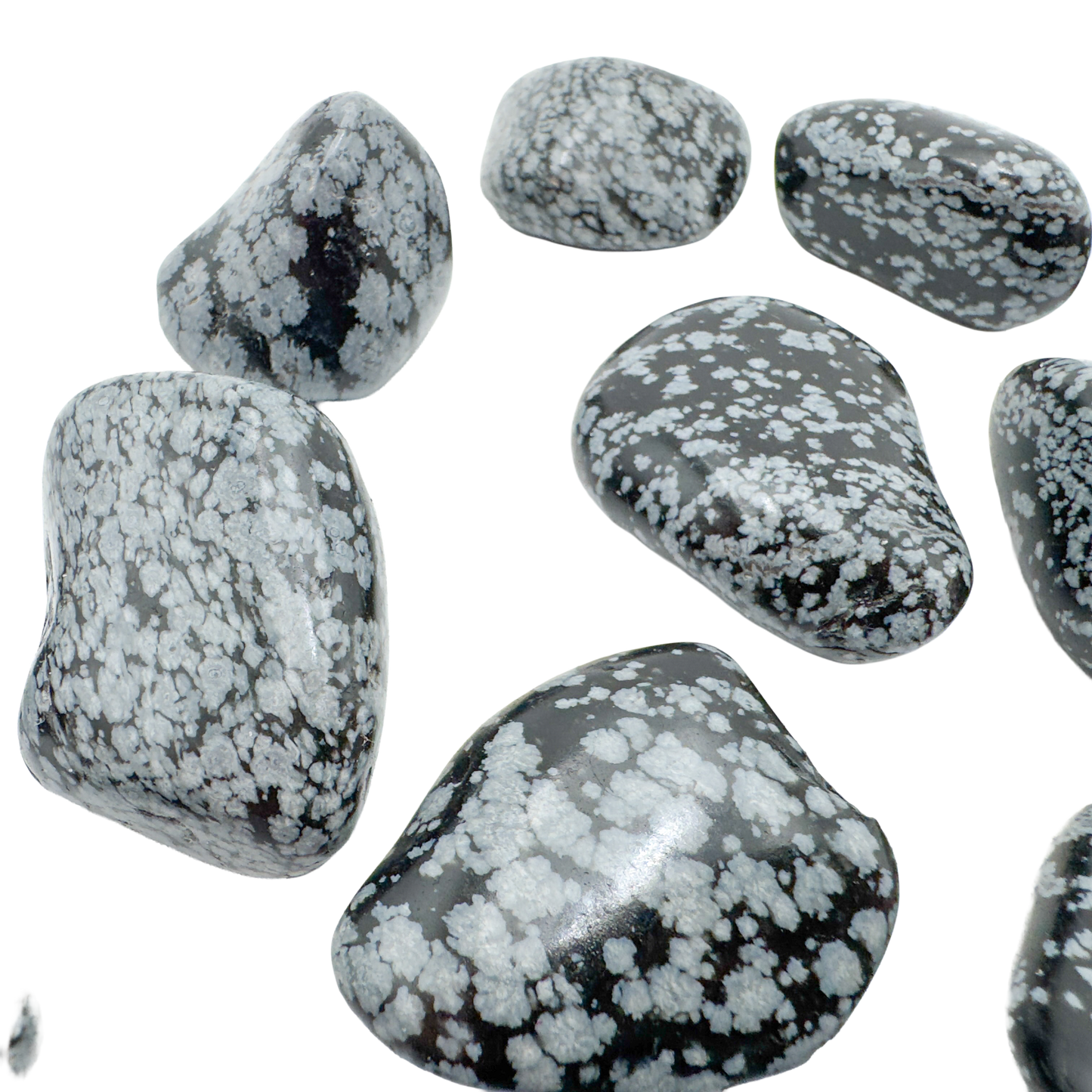 Snowflake Obsidian tumbled stones angled to show satin polish and pattern contrast