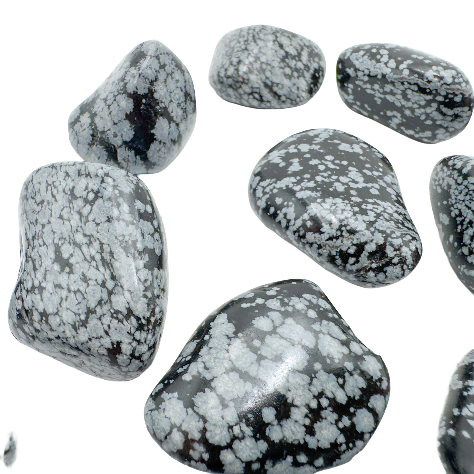 Snowflake Obsidian tumbled stones angled to show satin polish and pattern contrast
