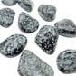 Several AA grade Snowflake Obsidian palm stones showing snowflake density variation