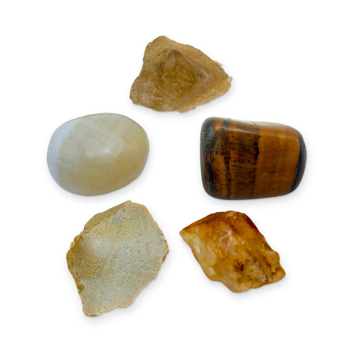 Solar Plexus Chakra Crystal Kit: natural citrine, tiger eye, golden healer, yellow jasper and honey calcite, shown together on white