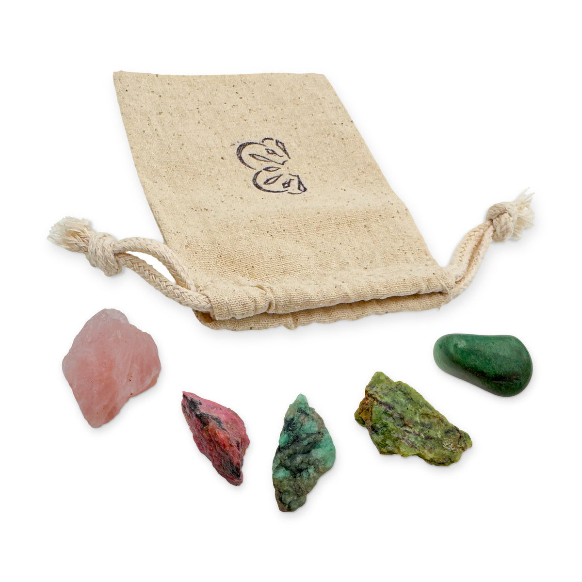 Taurus Crystal Kit: rose quartz, rhodonite, emerald, chrysoprase and green aventurine, arranged with the reusable cotton bag they come in, on white