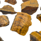 Tiger Eye raw stones angled to show natural unpolished surfaces and fiber direction