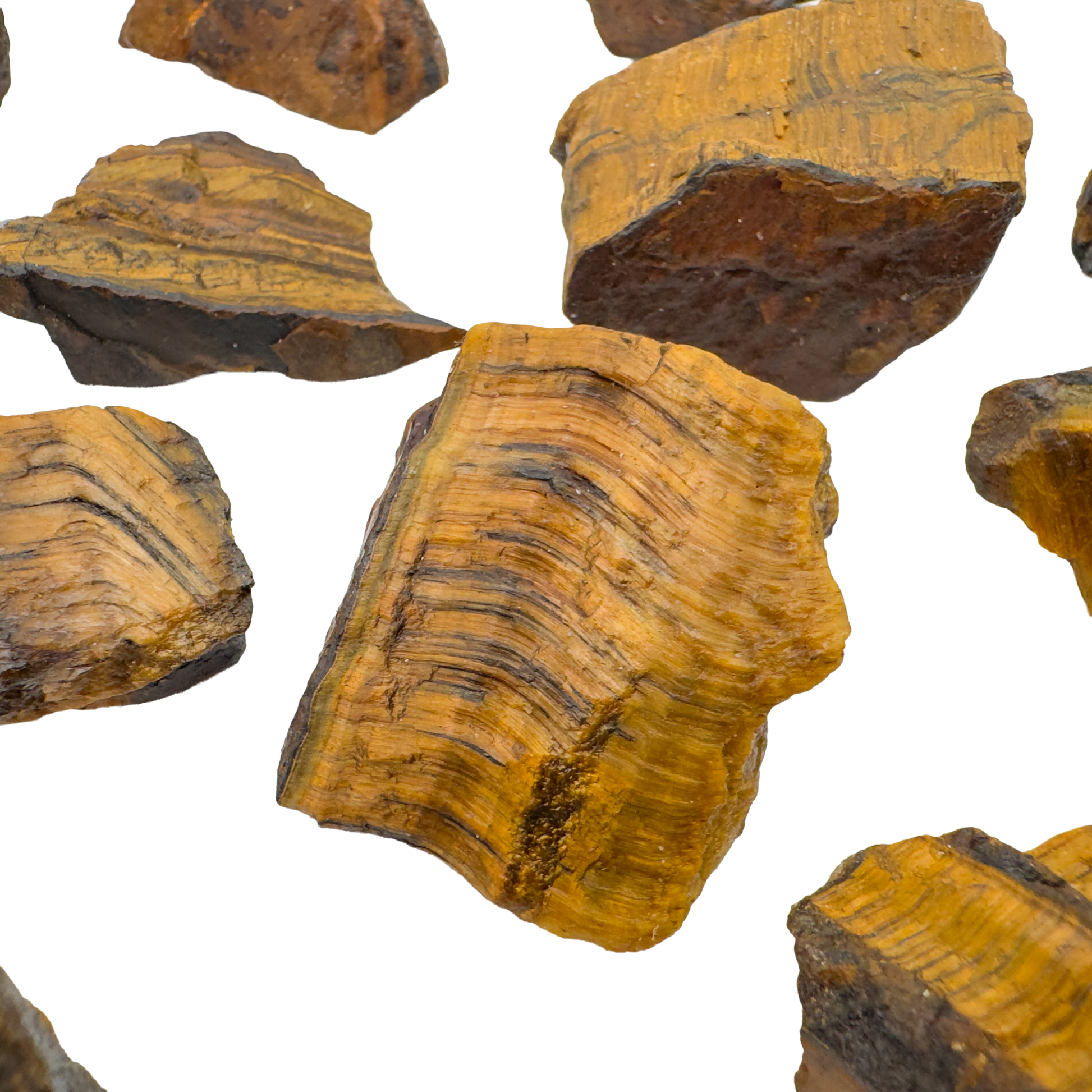 Tiger Eye raw stones angled to show natural unpolished surfaces and fiber direction