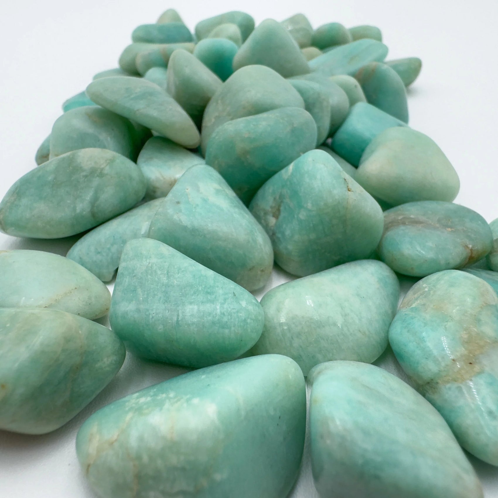Close-up of Amazonite tumbled stone from Brazil, soothing wellness stone for Emotional Healing