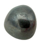 Hematite Tumbled Stones, AA Grade, Brazil: one tumbled stone on a white background, metallic silver gray with a dark polished face